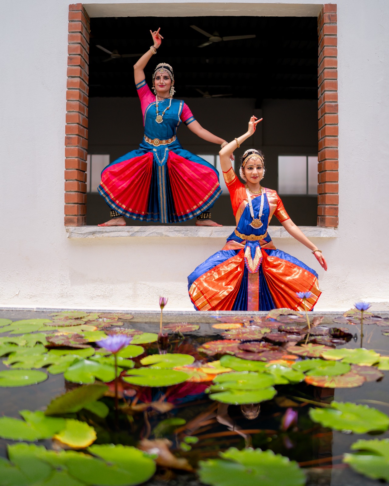 Prathiba standing in performance costume beneath stage lights